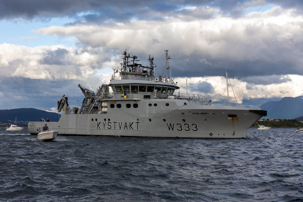 A coast guard vessel at sea under a gray sky