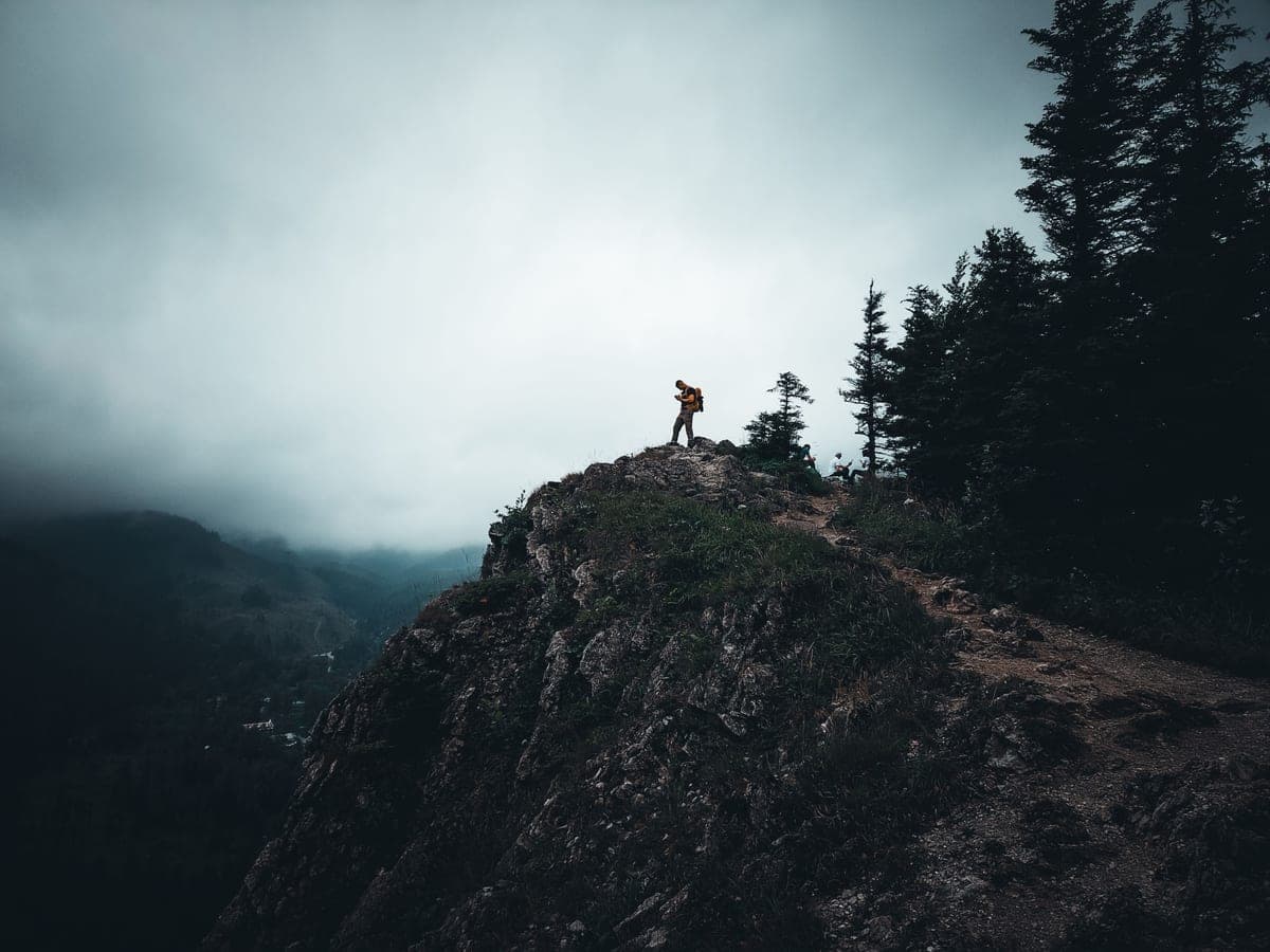 A man standing among rocky mountain peaks
